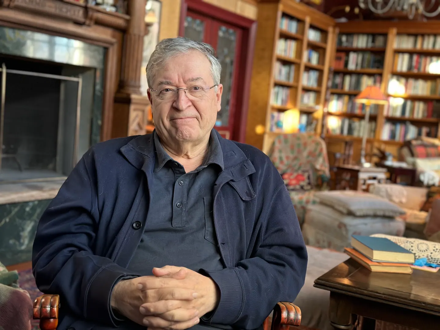 Interview subject seated in a book-lined library.
