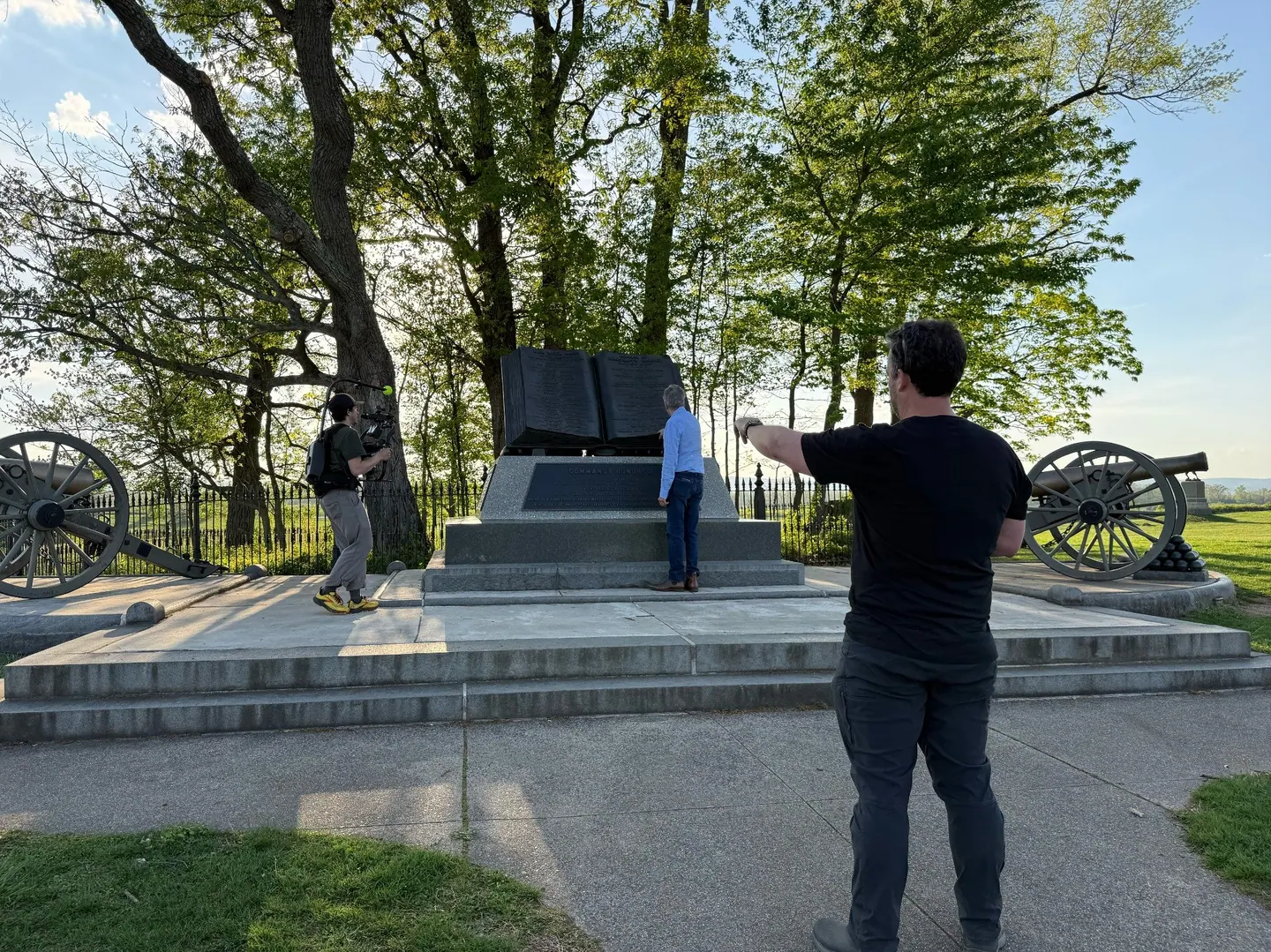 The film crew shoots at the High Water Mark monument, Gettysburg, as the director points toward the camera operator.